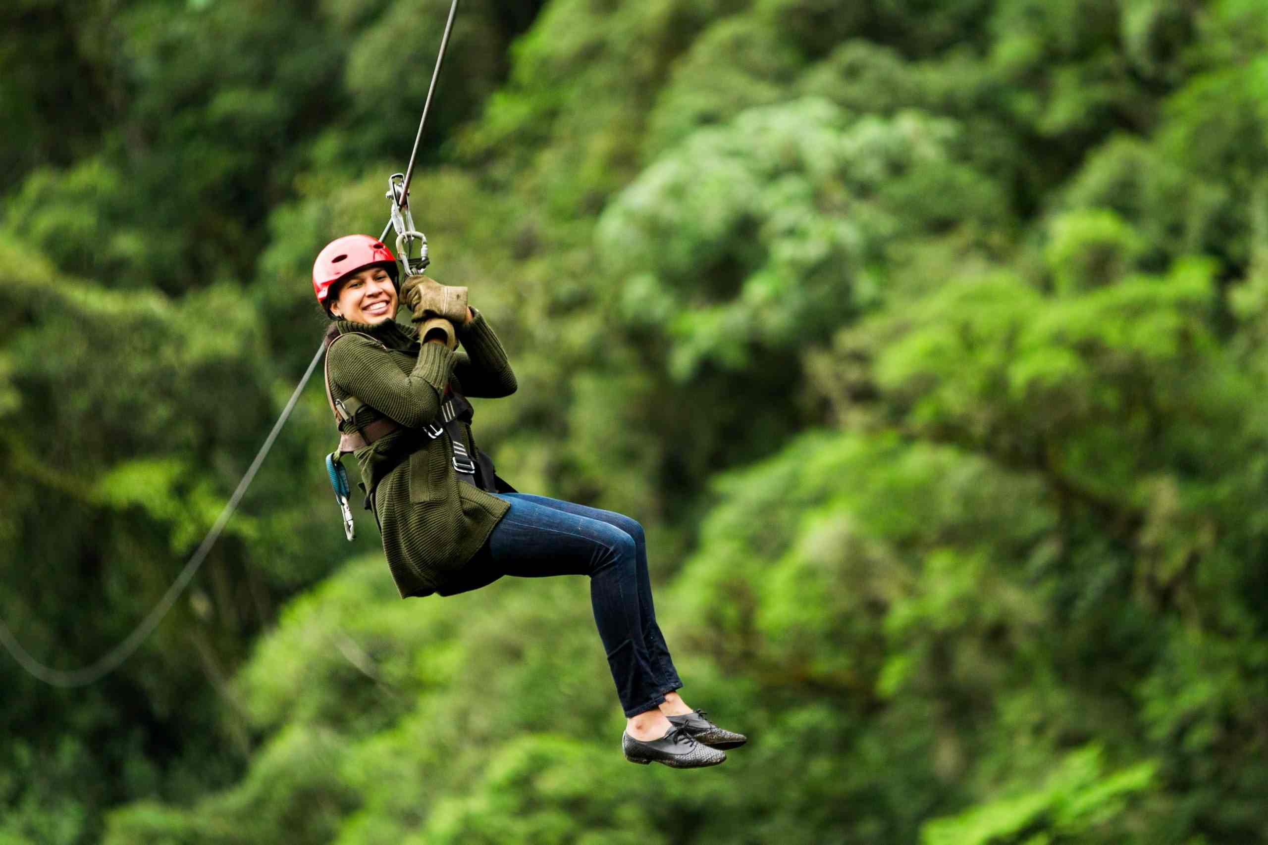 Bocawina Zipline Adventure: Close-up of a woman ziplining, capturing the excitement of the experience.