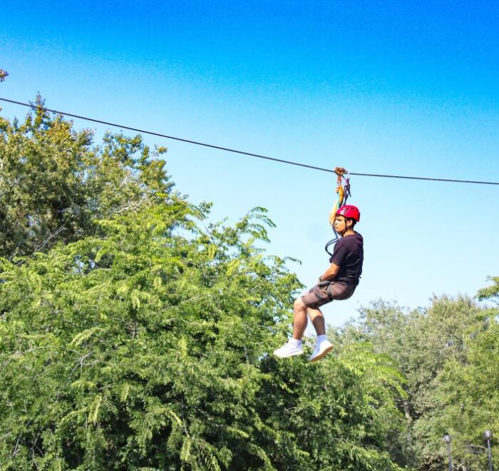 Bocawina Zipline Adventure: Guy enjoying a thrilling ziplining experience in Belize's rainforest.